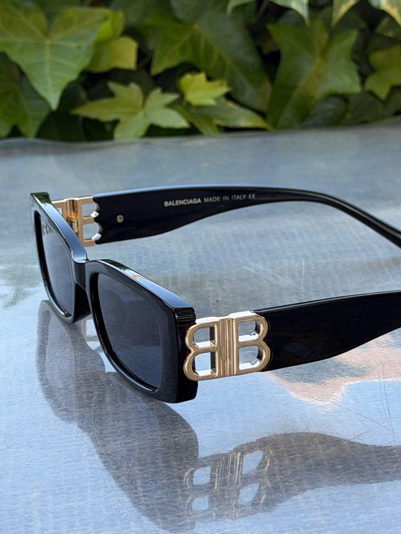 Balenciaga BB Logo Sunglasses Black (Category: Sunglasses & Eyewear) located in Manila. Submitted by urbanglasses.mnl (Listing ID 1442913216, Image 1). Description: - Features Gold BB Logo on Sides - Made in Italy - Rectangular Frame Shape - Ideal for Sunny Days - Versatile Accessory for Any Outfit.