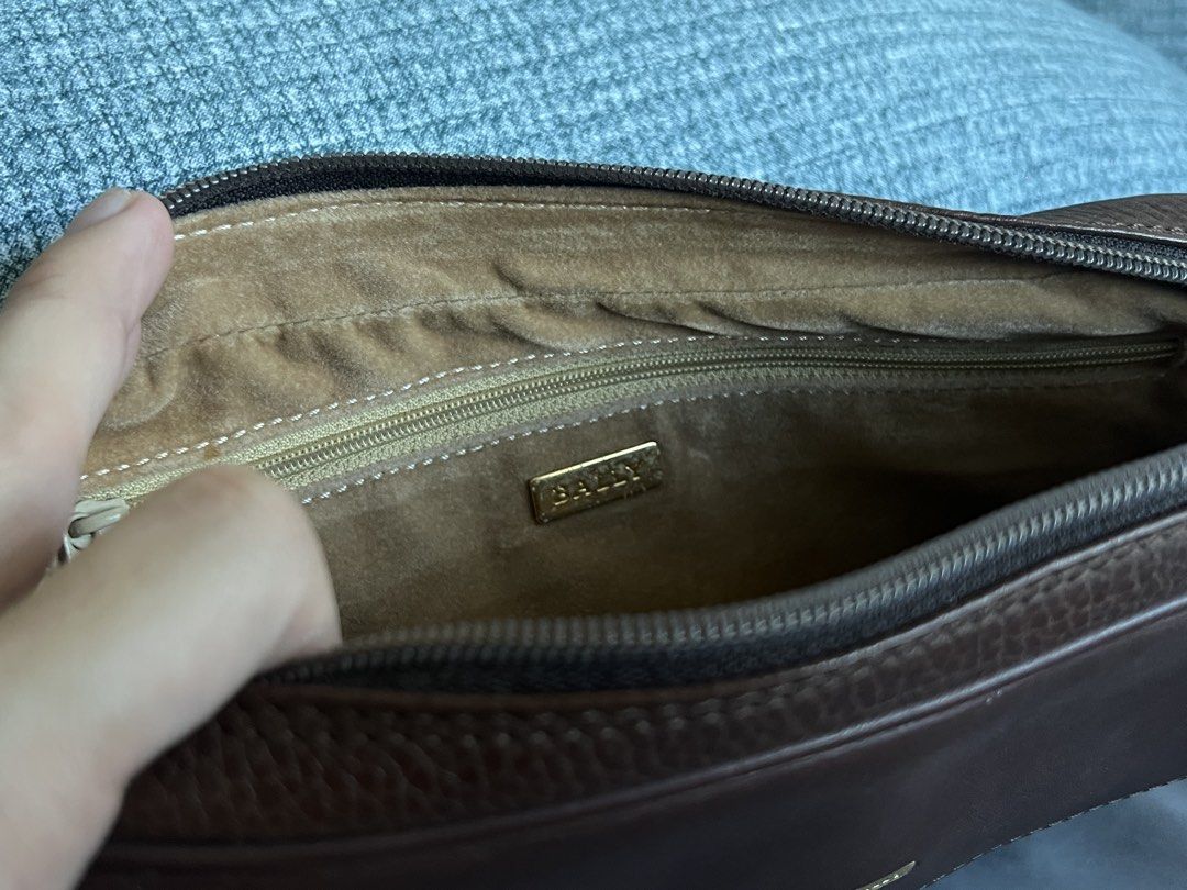Bally Brown Leather Clutch Bag (Category: Luxury Bags & Wallets) located in Mandaluyong City. Submitted by thincrustpizza123 (Listing ID 1442796553, Image 2). Description: - brown pebbled leather - classic, timeless look - Main compartment with zip closure - Interior zip and slip pockets - Small exterior zip pocket on the back - Gold tone hardware - Ideal for carrying essentials - purchased at an invite-only vintage sale in Hong Kong - condition: