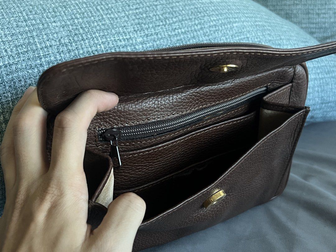 Bally Brown Leather Clutch Bag (Category: Luxury Bags & Wallets) located in Mandaluyong City. Submitted by thincrustpizza123 (Listing ID 1442796553, Image 3). Description: - brown pebbled leather - classic, timeless look - Main compartment with zip closure - Interior zip and slip pockets - Small exterior zip pocket on the back - Gold tone hardware - Ideal for carrying essentials - purchased at an invite-only vintage sale in Hong Kong - condition: