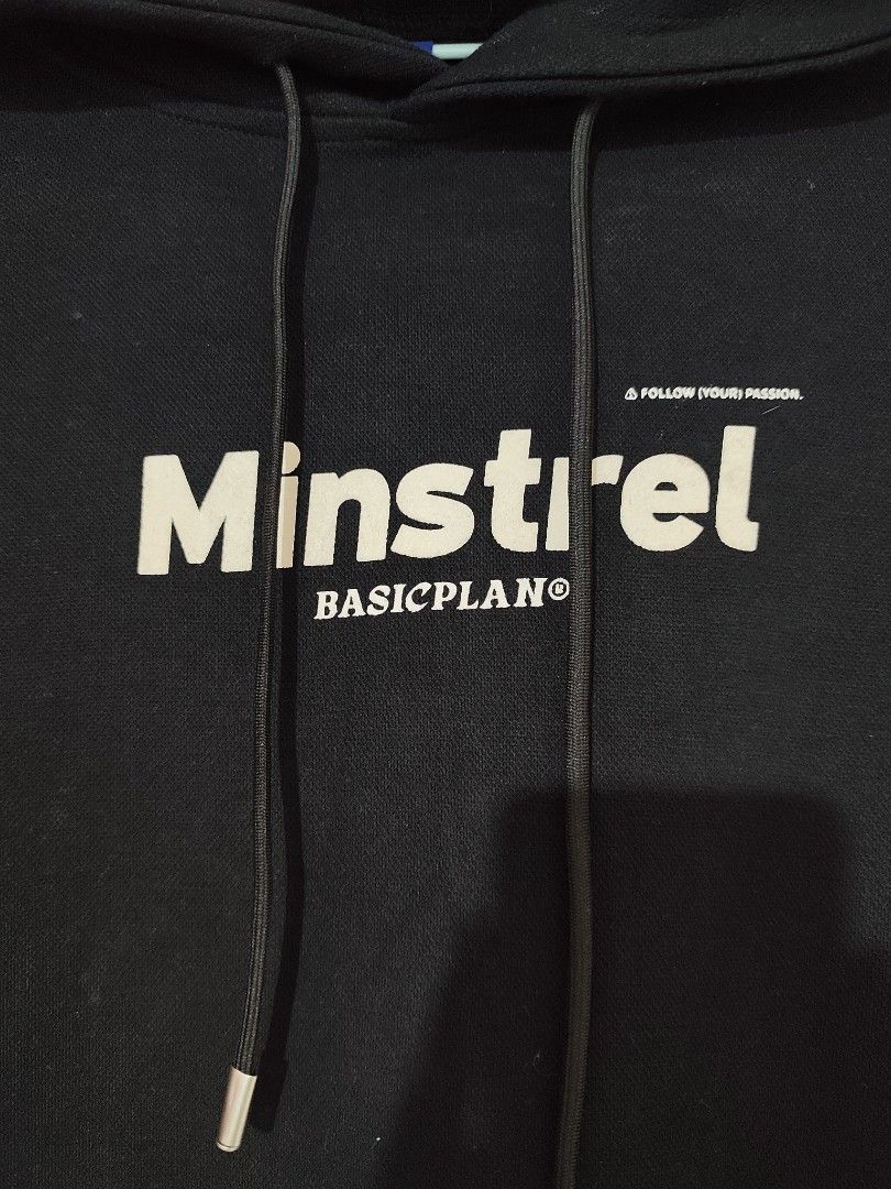 BASIC PLAN Minstrel Hoodie Black XL (Category: Hoodies) located in Taytay. Submitted by PrelovedCollections (Listing ID 1442740818, Image 2). Description: - Brand: BASIC PLAN - Color: Black - Size: XL - Features: 'Minstrel' and 'BASICPLAN' graphic on front, 'A FOLLOW YOUR PASSION' text - Labeling: 'BASIC PLAN' on sleeve and inside - Ideal for: Casual wear Heavy cloth Loc: Teresa Rizal GCASH ready tiktok checkout.