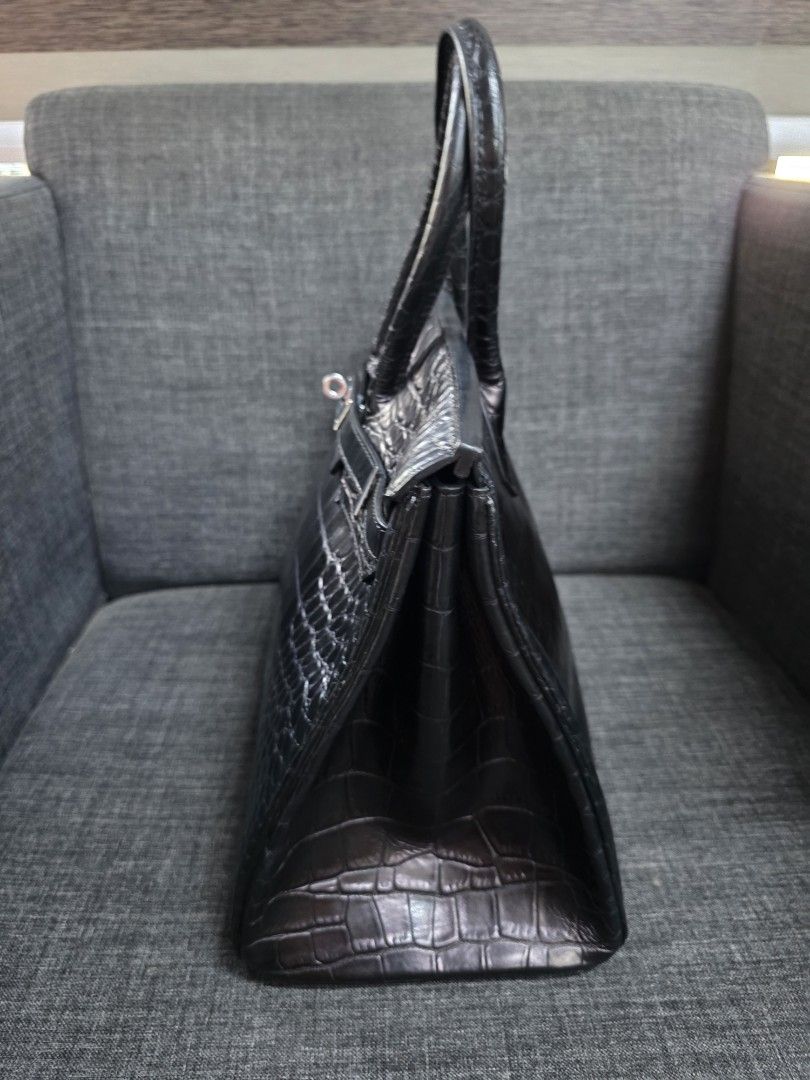 Black Crocodile Embossed Handbag with Silver Clasp (Category: Luxury Bags & Wallets) located in General Trias. Submitted by roselle2230 (Listing ID 1442888813, Image 3). Description: - Elegant black handbag - Crocodile embossed texture - Silver-tone clasp closure - Comfortable top handles - Structured, classic design - Versatile for everyday or special events.