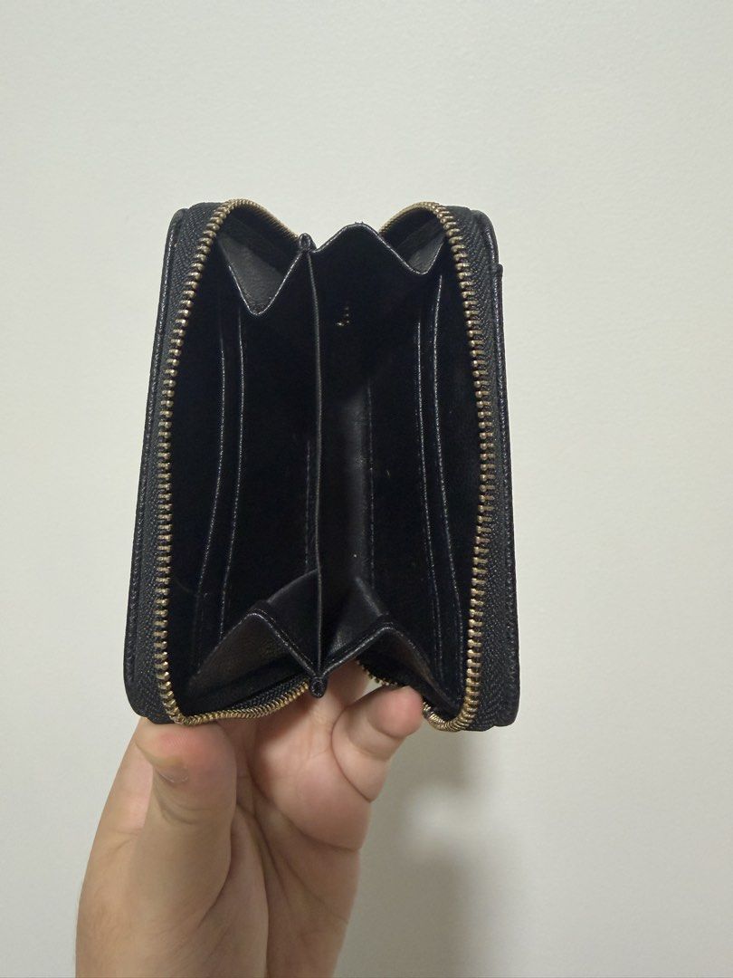 Black Zipper Coin Pouch Card Holder (Category: Wallets & Card holders) located in Quezon City. Submitted by shop_piascloset (Listing ID 1442812204, Image 2). Description: - Black wallet with secure zipper closure. - Convenient exterior card slots for quick access. - Interior includes multiple compartments for organization. - Ideal for keeping coins and cards tidy and separate. - Compact design easily fits into pockets or small bags..
