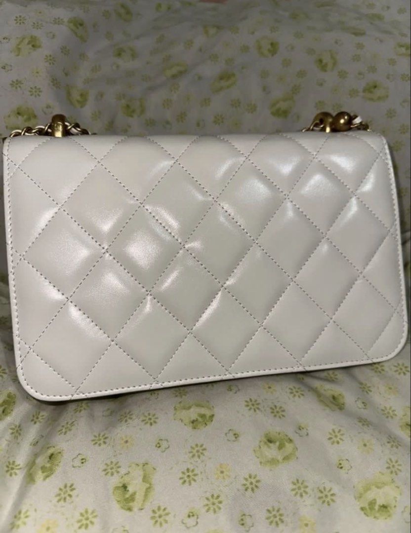 Chanel Perfect Fit white flap bag (Category: Shoulder Bags) located in Pasig City. Submitted by missdierdre (Listing ID 1442862659, Image 2). Description: - Chanel Perfect Fit white flap bag - aged gold hardware - adjustable ball chain, can be crossbody, shoulder or top handle bag - Quilted classic leather exterior - Versatile for dressing up or down - Timeless piece for any collection - used twice lang halos new ito - NGA but the stitching is rl