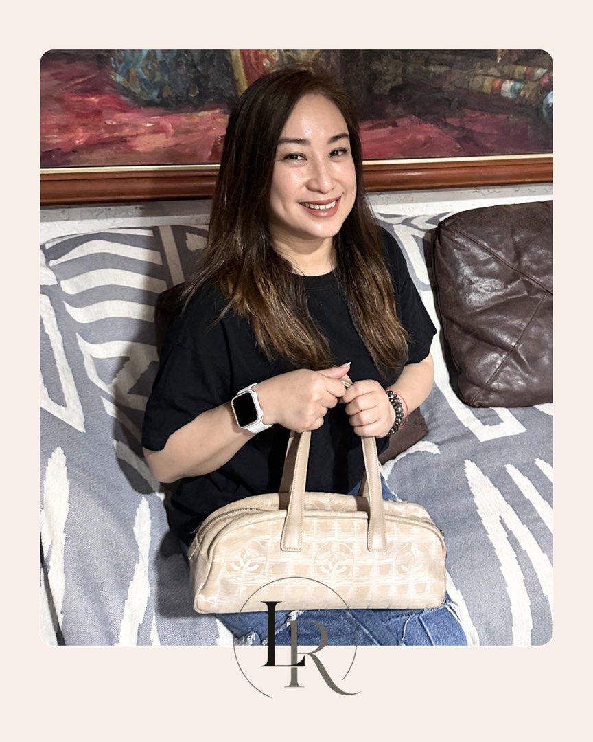 Chanel Travel Line Boston Bag (Category: Luxury Bags & Wallets) located in Quezon City. Submitted by elaine_t_dj (Listing ID 1442810466, Image 2). Description: - Authentic Chanel Travel Line Boston Bag - Color: Beige canvas with iconic CC logo pattern - Material: Durable canvas with genuine leather handles and trim - Closure: Secure zipper closure - Interior: Shows some signs of dirt - Hardware: Exhibits fading and scratches - Exterior: Light rub
