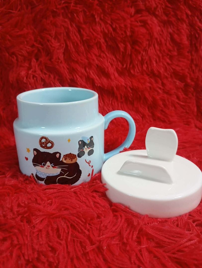 Cute Ceramic Mug with Lid (Category: Coffee & Tea Tableware) located in Caloocan City. Submitted by letsyrk (Listing ID 1442805823, Image 3). Description: - Adorable ceramic mugs with matching lids. - Available designs: Blue ombre dolphin, brown bear, raccoon, light blue blob, Christmas cat. - Ideal for coffee, tea, or hot chocolate. - Makes a great gift or a fun addition to your kitchen. - Each mug features a unique, playful design..