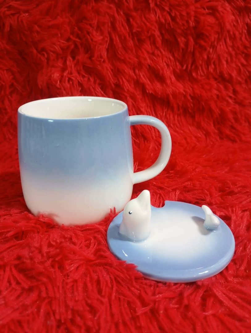 Cute Ceramic Mug with Lid (Category: Coffee & Tea Tableware) located in Caloocan City. Submitted by letsyrk (Listing ID 1442805823, Image 1). Description: - Adorable ceramic mugs with matching lids. - Available designs: Blue ombre dolphin, brown bear, raccoon, light blue blob, Christmas cat. - Ideal for coffee, tea, or hot chocolate. - Makes a great gift or a fun addition to your kitchen. - Each mug features a unique, playful design..