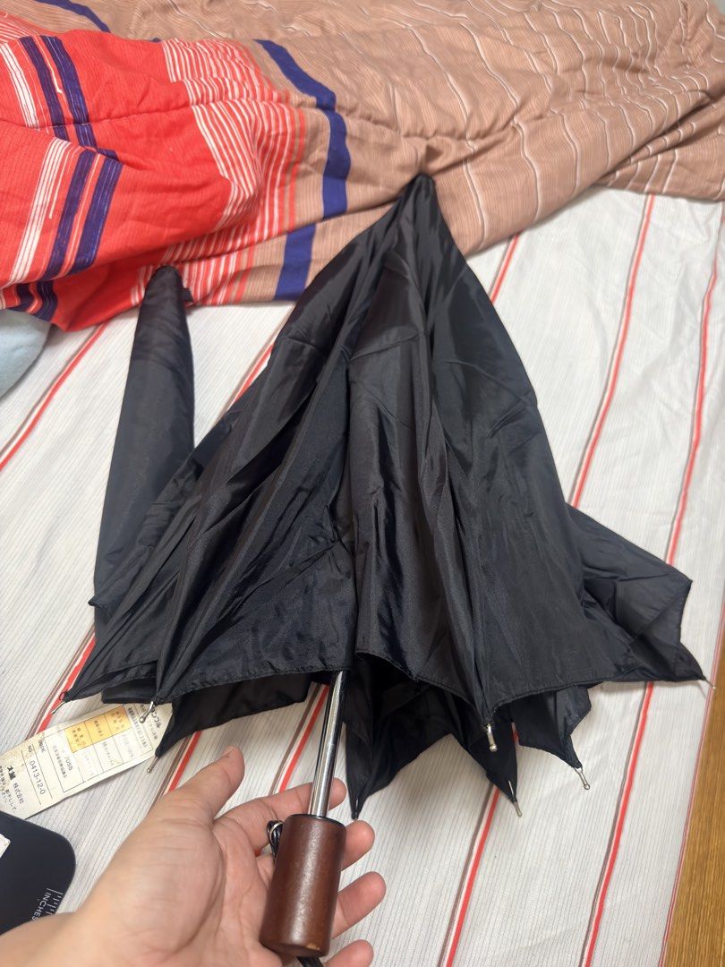 Danble Umbrella for Men - Black (Category: Umbrellas) located in Pilar. Submitted by faveanyshop (Listing ID 1442924904, Image 3). Description: - Black foldable umbrella - Features a classic wooden handle - Includes a convenient wrist strap - Still has its original tag attached - Styled for men, ideal for rainy weather - Compact and easy to carry wherever you go.