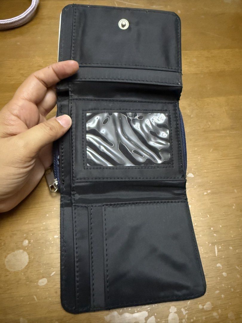 Denim Tri-Fold Wallet with Guitar Design (Category: Wallets & Card holders) located in Pilar. Submitted by faveanyshop (Listing ID 1442763262, Image 3). Description: - Adorable denim wallet - Features a row of colorful guitars on the front - Zippered coin pocket on the side - Includes a clear ID window and card slots - Plenty of space for your essentials - 'Jake' is printed on the front.