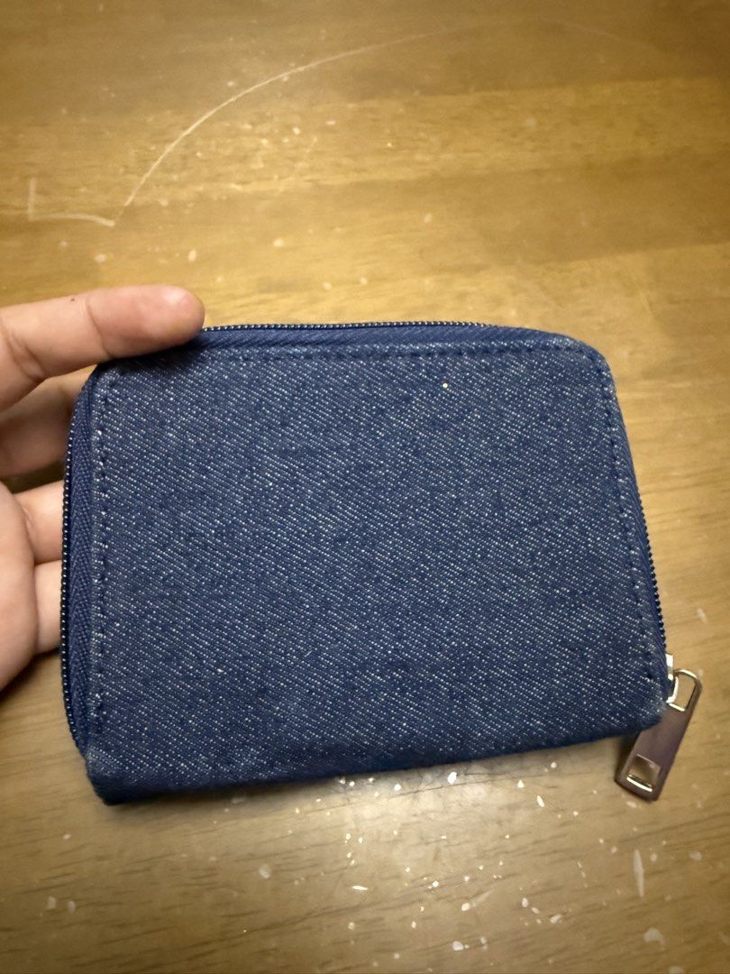 Denim Tri-Fold Wallet with Guitar Design (Category: Wallets & Card holders) located in Pilar. Submitted by faveanyshop (Listing ID 1442763262, Image 2). Description: - Adorable denim wallet - Features a row of colorful guitars on the front - Zippered coin pocket on the side - Includes a clear ID window and card slots - Plenty of space for your essentials - 'Jake' is printed on the front.