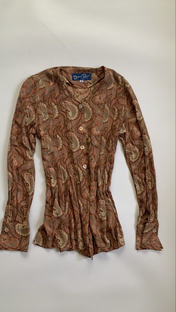 Diane Du Paris Paisley Print Button-Up Blouse (Category: Blouses) located in Tarlac. Submitted by luv__vintage (Listing ID 1442787828, Image 3). Description: - Stylish long sleeve blouse with a beautiful paisley print. - Classic button-up front design. - Flattering gathered waist detail. - Fabric drapes beautifully for an elegant look. - Perfect for pairing with jeans or skirts. - Suitable for both casual outings and dressier events..