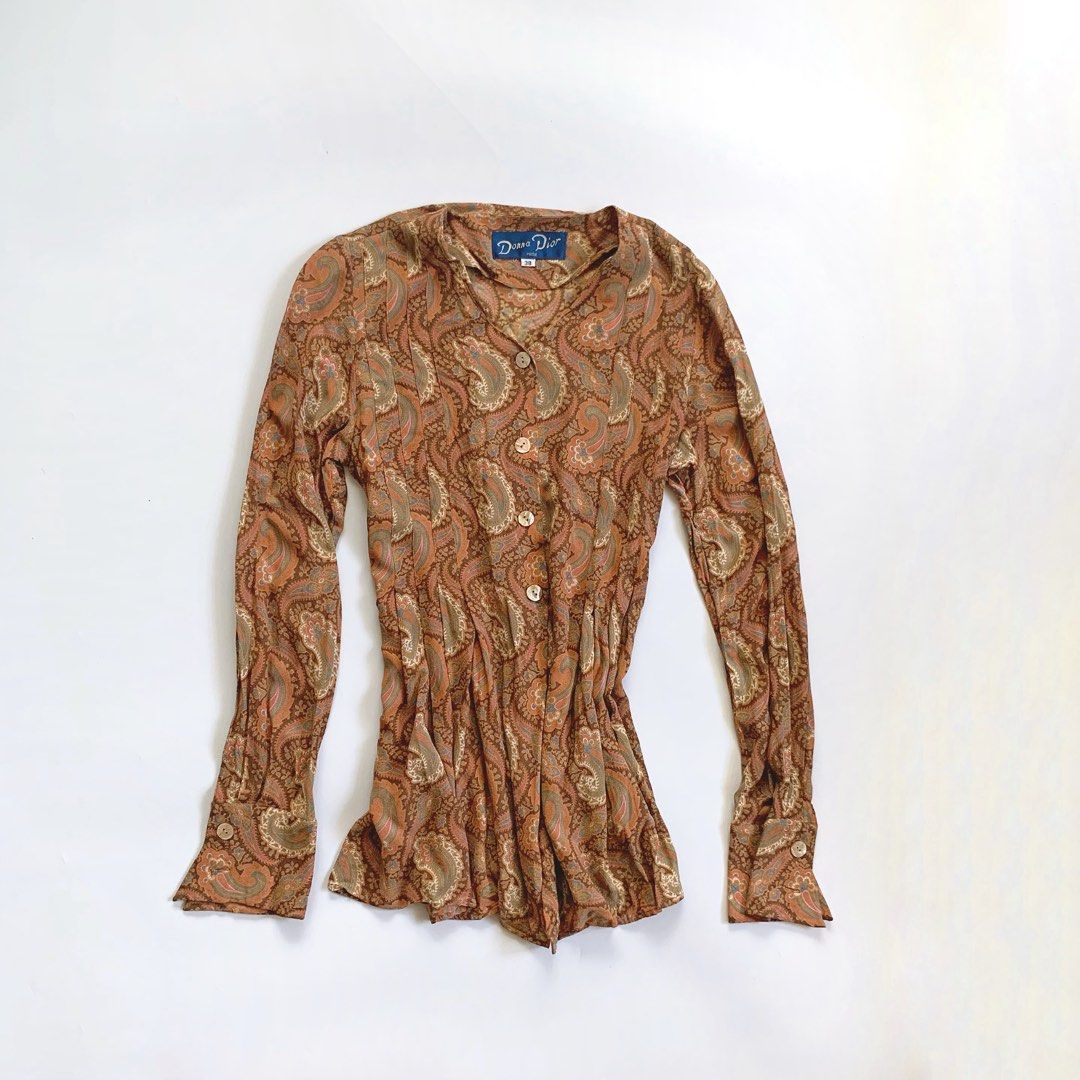Diane Du Paris Paisley Print Button-Up Blouse (Category: Blouses) located in Tarlac. Submitted by luv__vintage (Listing ID 1442787828, Image 2). Description: - Stylish long sleeve blouse with a beautiful paisley print. - Classic button-up front design. - Flattering gathered waist detail. - Fabric drapes beautifully for an elegant look. - Perfect for pairing with jeans or skirts. - Suitable for both casual outings and dressier events..