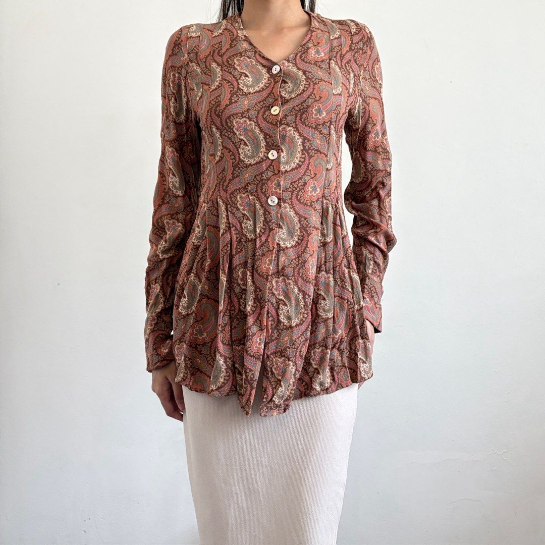 Diane Du Paris Paisley Print Button-Up Blouse (Category: Blouses) located in Tarlac. Submitted by luv__vintage (Listing ID 1442787828, Image 1). Description: - Stylish long sleeve blouse with a beautiful paisley print. - Classic button-up front design. - Flattering gathered waist detail. - Fabric drapes beautifully for an elegant look. - Perfect for pairing with jeans or skirts. - Suitable for both casual outings and dressier events..