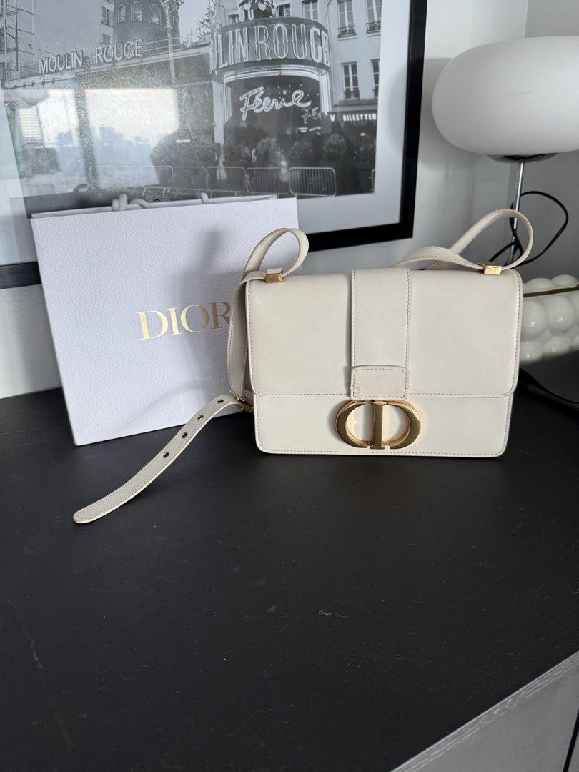 Dior White Leather Shoulder Bag with Gold CD Clasp (Category: Luxury Bags & Wallets) located in Mandaluyong City. Submitted by mamasamshops (Listing ID 1442770568, Image 1). Description: - Authentic white leather Dior shoulder bag - Iconic gold CD clasp closure - Comes with a red and cream patterned silk scarf tied to the strap twilly to cover the claw - Includes original Dior paper bag only .