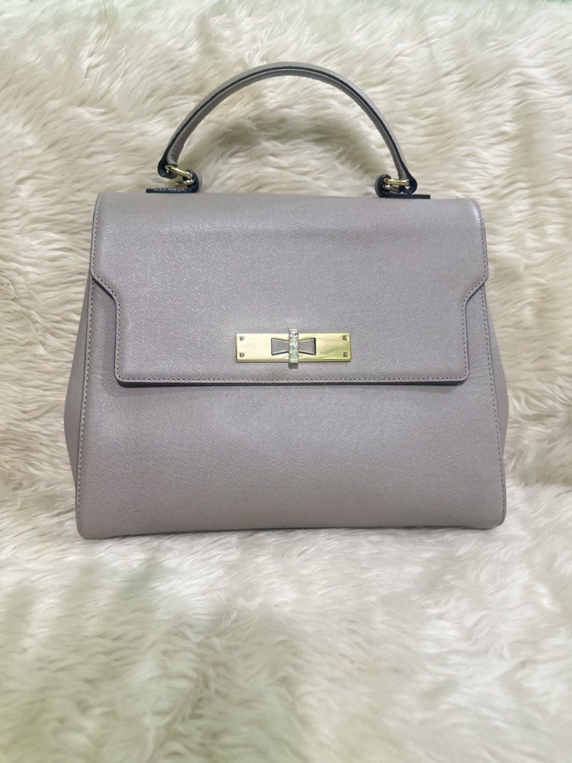 Authentic Lovcat Gray Top Handle Bag with Gold Clasp (Category: Luxury Bags & Wallets) located in Angeles City. Submitted by chicprelovedstuffs.owl (Listing ID 1442775133, Image 2). Description: FREE SHIPPING‼️‼️ Preloved Lovcat top handle bag Signs of use in hardware but no rubs, almost like new ang bag itself Perfect for office or special occasion Rfs: Decluttering Courier: J&T or LBC COP - Elegant grey top handle bag - Secure gold clasp closur