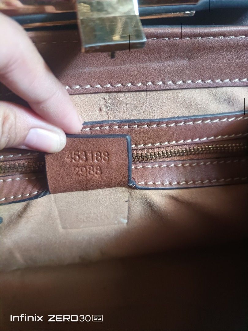 Gucci Brown Leather Handbag with Gold Lock (Category: Luxury Bags & Wallets) located in Manila. Submitted by feliajenny76751 (Listing ID 1442768995, Image 3). Description: - Genuine brown leather Gucci handbag - Elegant gold lock closure - Interior zipper pocket for essentials - Authenticity guaranteed: Made in Italy - Serial number: 453188 2988 -Gucci Under Zip -With Etiketa.