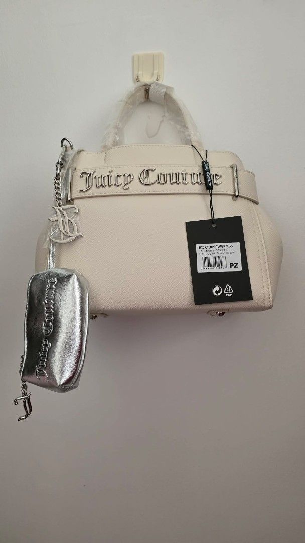 Juicy Couture Cream Handbag with Silver Pouch (Category: Purses & Pouches) located in San Leonardo. Submitted by arni0179 (Listing ID 1442882626, Image 1). Description: - Cream-colored Juicy Couture handbag - Includes matching silver pouch attached - Prominent Juicy Couture logo on the front - Protective metal feet on the bottom - Brand new with tags still attached - Versatile for everyday use or evening events.