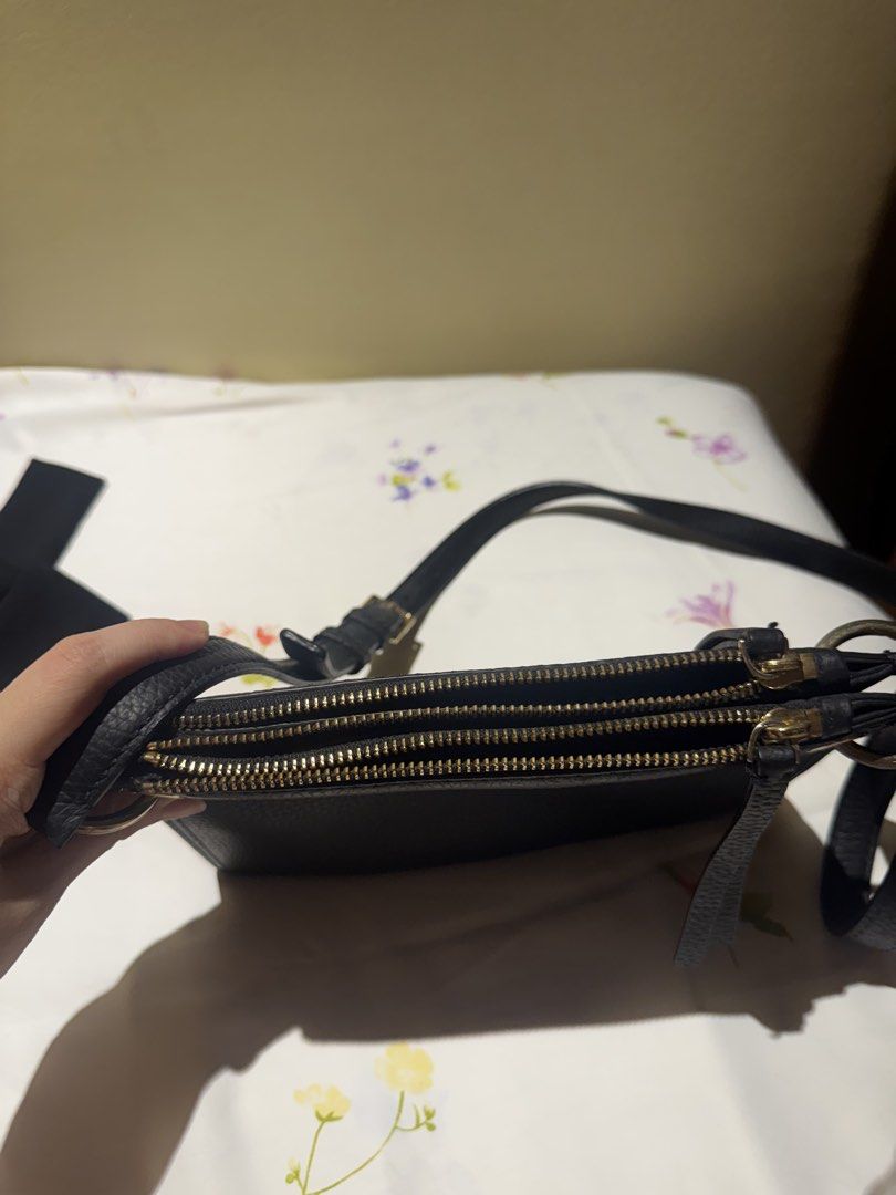 Kate Spade Black Leather Crossbody Bag (Category: Cross-body Bags) located in Quezon City. Submitted by 0913cartz (Listing ID 1442864656, Image 2). Description: - Authentic Kate Spade black leather crossbody bag - Two spacious zippered main compartments and middle compartment (total of 3 compartments) - Elegant gold hardware details - Adjustable strap for comfortable wear - Chic striped interior lining - Ideal for everyday essentials or a night o