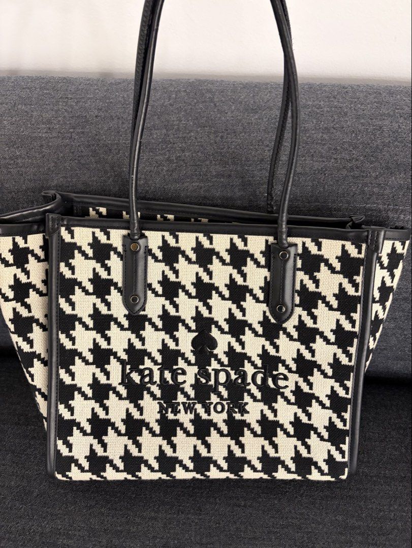 Kate Spade New York Houndstooth Tote Bag (Category: Tote Bags) located in Pasig City. Submitted by preloved_items_roche (Listing ID 1442736313, Image 1). Description: - Classic Kate Spade tote bag - Stylish black and white houndstooth pattern - Genuine leather trim and handles - Interior zippered pocket and slip pocket - Spacious and versatile for everyday or travel.