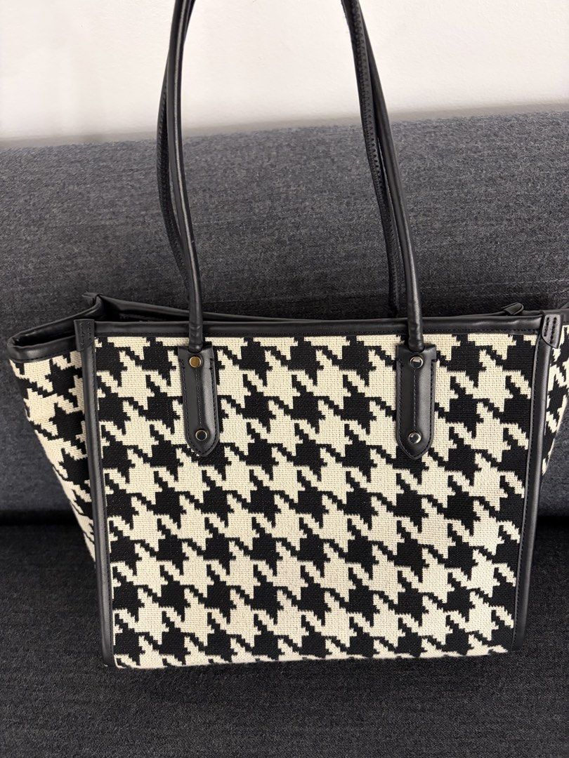 Kate Spade New York Houndstooth Tote Bag (Category: Tote Bags) located in Pasig City. Submitted by preloved_items_roche (Listing ID 1442736313, Image 3). Description: - Classic Kate Spade tote bag - Stylish black and white houndstooth pattern - Genuine leather trim and handles - Interior zippered pocket and slip pocket - Spacious and versatile for everyday or travel.