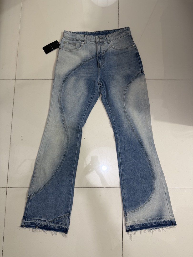 Light Wash Flared Jeans with Panel Design (Category: Jeans) located in Makati City. Submitted by thhird (Listing ID 1442898963, Image 1). Description: - Light wash denim jeans - Unique wavy panel design - Flared leg opening - Raw hem detail.