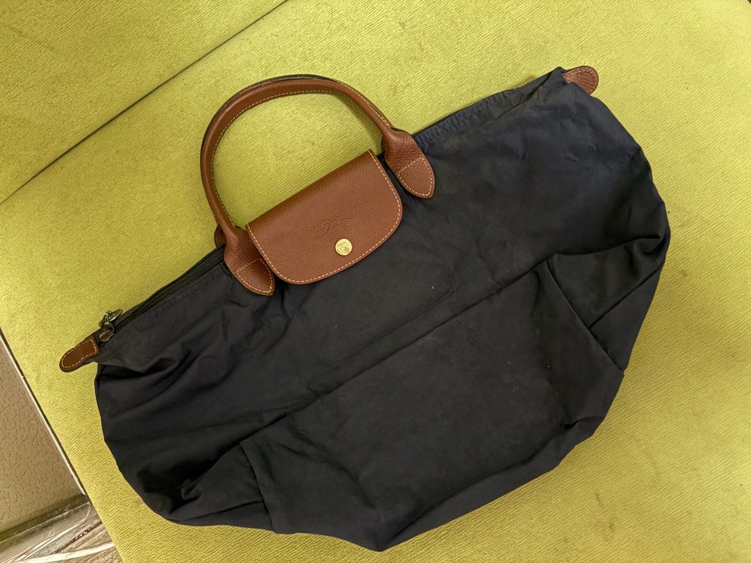 Longchamp Le Pliage Cuir Small Top Handle Bag Navy (Category: Luxury Bags & Wallets) located in Muntinlupa City. Submitted by koi_143 (Listing ID 1442849091, Image 3). Description: - Navy blue Longchamp bag - Genuine leather handles and trim - Secure zipper closure - Folds compactly for easy storage - Ideal for daily use with ample interior space.