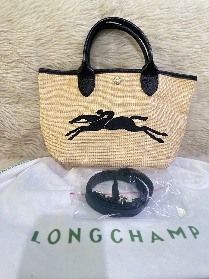 Longchamp Le Pliage Cuir Straw Tote Bag (Category: Luxury Bags & Wallets) located in Angeles City. Submitted by chicprelovedstuffs.owl (Listing ID 1442778476, Image 1). Description: Once used ; RFS: Decluttering Halos mukha pa talaga bago Comes with dustbag This is a Longchamp Le Panier Pliage straw-effect canvas tote bag featuring an embroidered black horse logo and black leather handle - Authentic Longchamp tote bag - Material: Straw with black