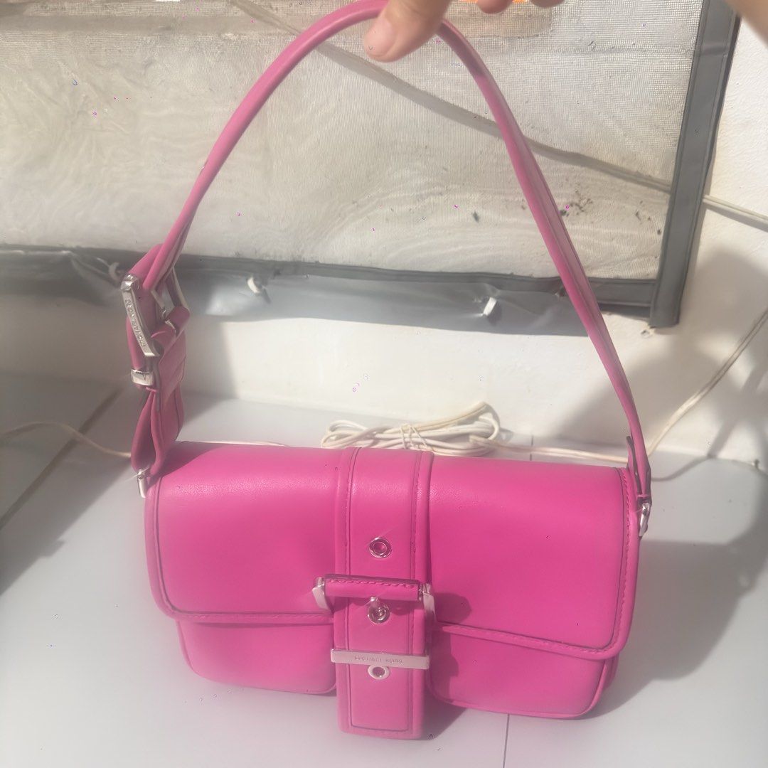 Michael Kors Pink Leather Shoulder Bag (Category: Luxury Bags & Wallets) located in Mabalacat. Submitted by kay_miscak (Listing ID 1442826305, Image 2). Description: - Authentic Michael Kors shoulder bag - Vibrant bright pink leather - Elegant silver buckle detail on front flap - Adjustable strap for comfortable wear - Two convenient front pockets - Ideal for adding a pop of color to any outfit - Perfect for daily use.