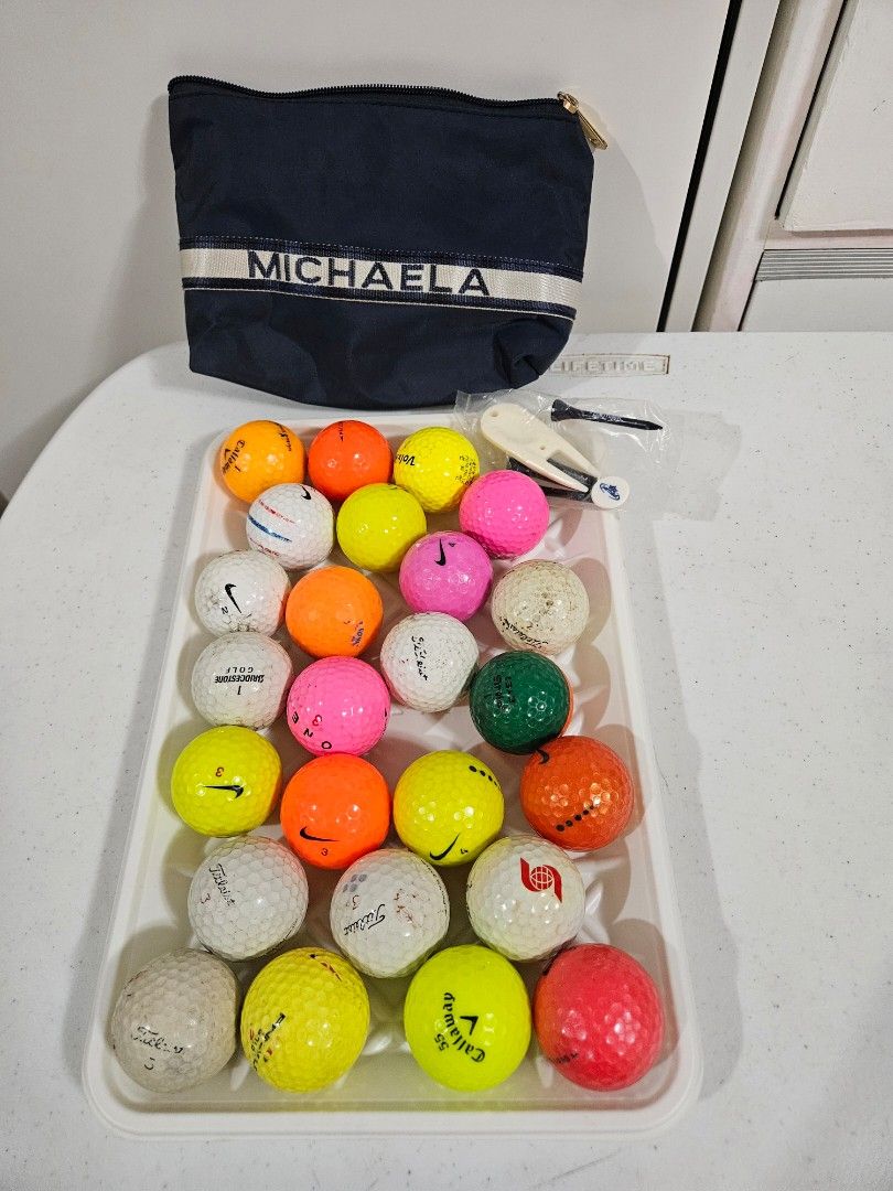 Mixed Golf Balls & Pouch (Category: Golf) located in Caloocan City. Submitted by rm.diaz (Listing ID 1442743325, Image 2). Description: - Bundle of assorted golf balls (various brands like Titleist, Nike, Callaway, and more) - Includes a navy pouch with 'MICHAELA' printed on it - Comes with a golf tee holder, tees, and a divot tool - Ideal for practice sessions or casual rounds of golf.