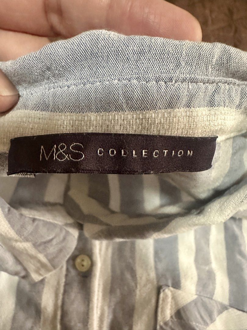 M&S Collection Blue & White Striped Button-Up Shirt (Category: Shirts) located in Quezon City. Submitted by declutter_incorporated (Listing ID 1442785573, Image 2). Description: - M&S Collection shirt - Blue and white vertical stripes - Chest pocket - Button-up front - Short sleeves with rolled cuffs - Comfortable and casual - Great for everyday wear.
