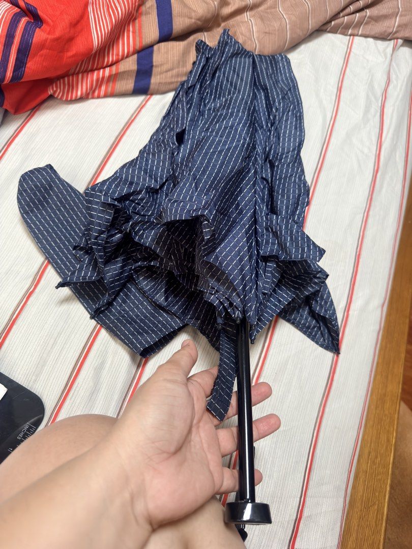 Nanotex Fabric UV Protection Umbrella (Category: Umbrellas) located in Pilar. Submitted by faveanyshop (Listing ID 1442924539, Image 3). Description: - Dark blue umbrella with a stylish grid pattern. - Features Nanotex fabric for excellent water repellency. - Provides UV protection, perfect for sunny days. - Compact and portable design for easy everyday carrying. - Ideal for both rainy and sunny weather conditions..