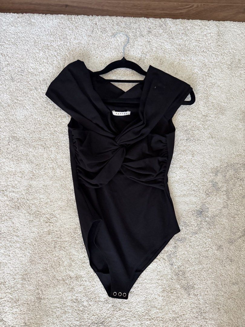 PATTON Black Off-Shoulder Twisted Bodysuit Size M (Category: Others Tops) located in Cebu City. Submitted by chicandcasualx (Listing ID 1442770467, Image 2). Description: Patton Draped Bodysuit – Black (Size Medium) Elegant and flattering Patton bodysuit featuring a statement draped neckline, structured silhouette, and snap-button closure. A versatile piece that can be dressed up for events or styled casually with jeans, trousers, or skirts. * Br