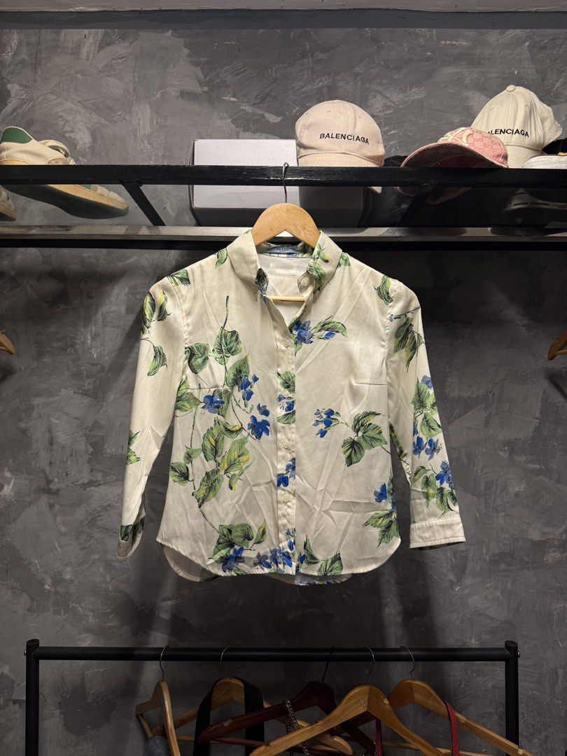Prada Milano Floral Print Button-Up Shirt (Category: Luxury Apparel) located in Legazpi City. Submitted by deadthrift (Listing ID 1442876073, Image 1). Description: - Authentic Prada Milano shirt - Dimensions: 16width | 21length - Size 36 (XS) - Beautiful floral print (blue flowers, green leaves on cream) - Classic button-up style with collar - Made in Italy - Versatile for dressing up or down.