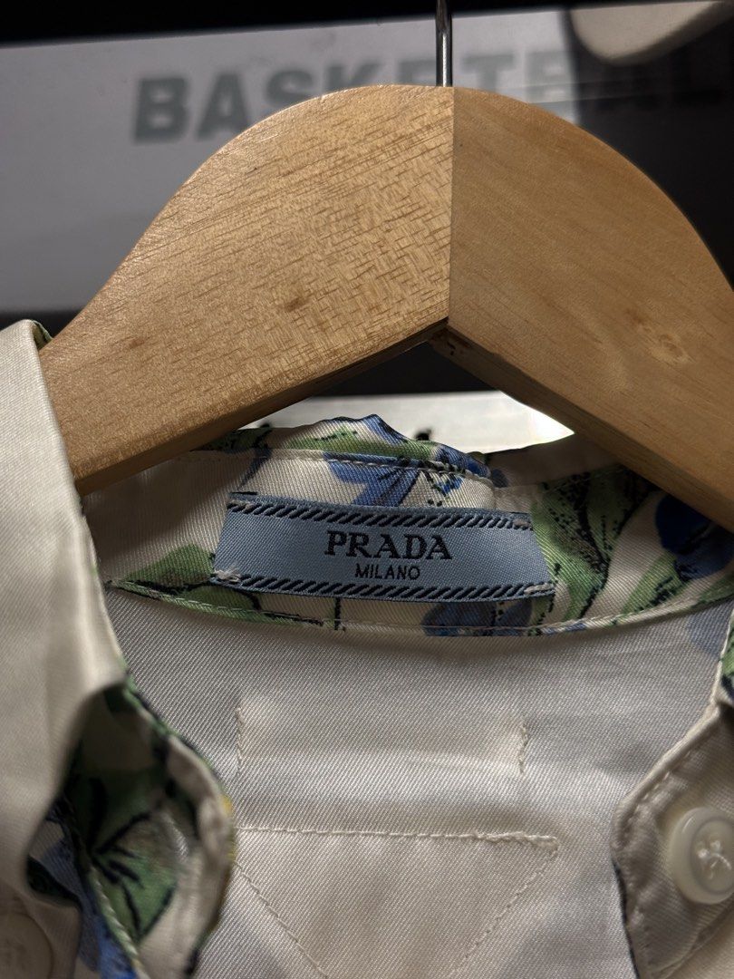 Prada Milano Floral Print Button-Up Shirt (Category: Luxury Apparel) located in Legazpi City. Submitted by deadthrift (Listing ID 1442876073, Image 3). Description: - Authentic Prada Milano shirt - Dimensions: 16width | 21length - Size 36 (XS) - Beautiful floral print (blue flowers, green leaves on cream) - Classic button-up style with collar - Made in Italy - Versatile for dressing up or down.