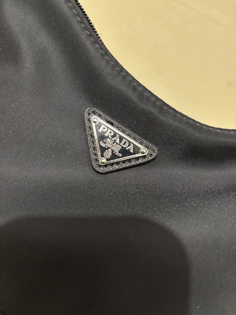Prada Re-Edition 2003 Nylon Shoulder Bag Black (Category: Luxury Bags & Wallets) located in Manila. Submitted by van390867 (Listing ID 1442823899, Image 2). Description: Self Authenticate - Classic Prada shoulder bag - Black nylon material - Iconic triangular Prada logo on front - Leather tag: 'Re-Edition 2003' - Zipper closure - Comfortable shoulder strap - Timeless piece.