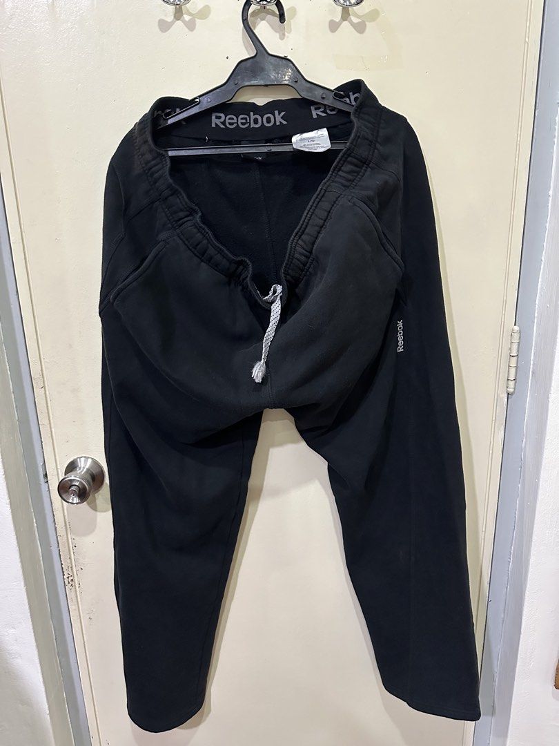 Reebok Black Sweatpants Joggers Size L (Category: Joggers) located in Manila. Submitted by roseluxuryitems (Listing ID 1442901238, Image 2). Description: - Reebok Black Sweatpants Joggers Size Large - Elastic waistband with adjustable drawstring - Reebok logo detail on waistband and leg - Soft fleece lining for added warmth - Ideal for casual wear, lounging, or workouts.