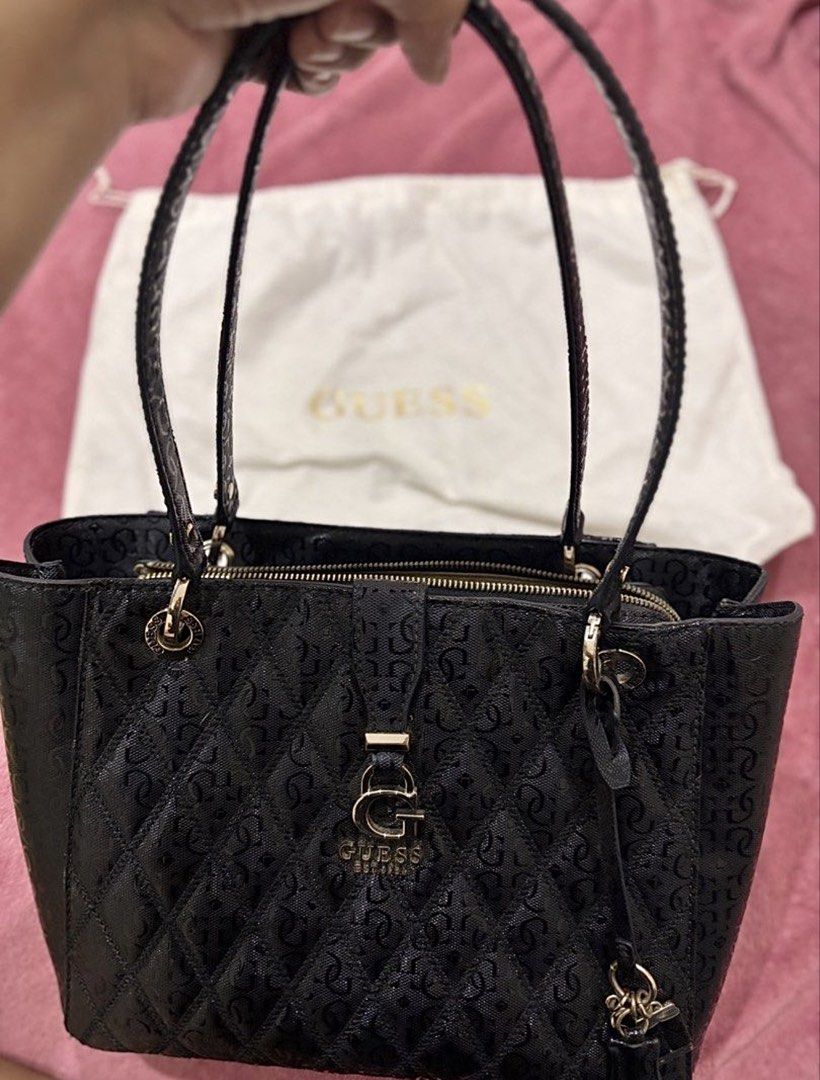 RUSH! GUESS Adi Small Noel Tote (Category: Luxury Bags & Wallets) located in Cavite. Submitted by zscknhmiera (Listing ID 1442734114, Image 1). Description: 📏 dimensions • width: 34.5 cm (13.6 inches) • height: 23.5 cm (9.25 inches) •depth: 9.5 cm (3.7 inches) ✨ condition •exterior: still very nice, no major flaws, holds shape well • hardware: still in good condition • interior: still in good condition also, no rips or tears 📦 inclusions: • ori