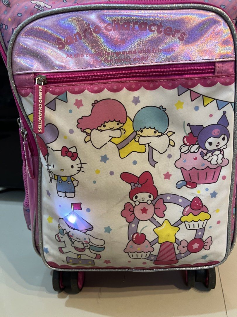 Sanrio Characters School Trolley & Lunch Bag Set (Category: Strollers) located in Marikina City. Submitted by aikavml (Listing ID 1442844668, Image 2). Description: - Sanrio Characters trolley & matching insulated lunch bag - Features Hello Kitty, My Melody, Little Twin Stars, Cinnamoroll and Kuromi - Bag has 360 wheels and a retractable handle for easy transport - Insulated Lunch bag conveniently attaches to the front of the main bag - Spacious 