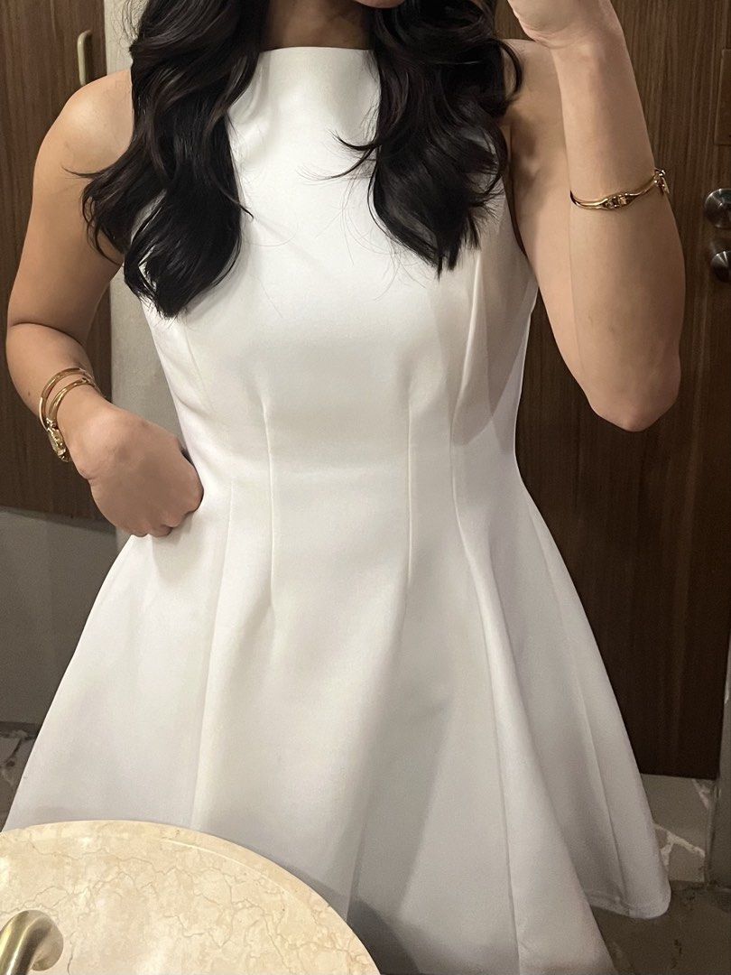 Sleeveless White A-Line Mini Dress (Category: Dresses) located in Dasmarinas. Submitted by 365daysofsummer (Listing ID 1442910743, Image 3). Description: - Sleeveless white dress - High neckline - A-line silhouette, flares from the waist - Above-the-knee length - Ideal for parties and events - Comfortable fit - Versatile for accessorizing - worn only twice.