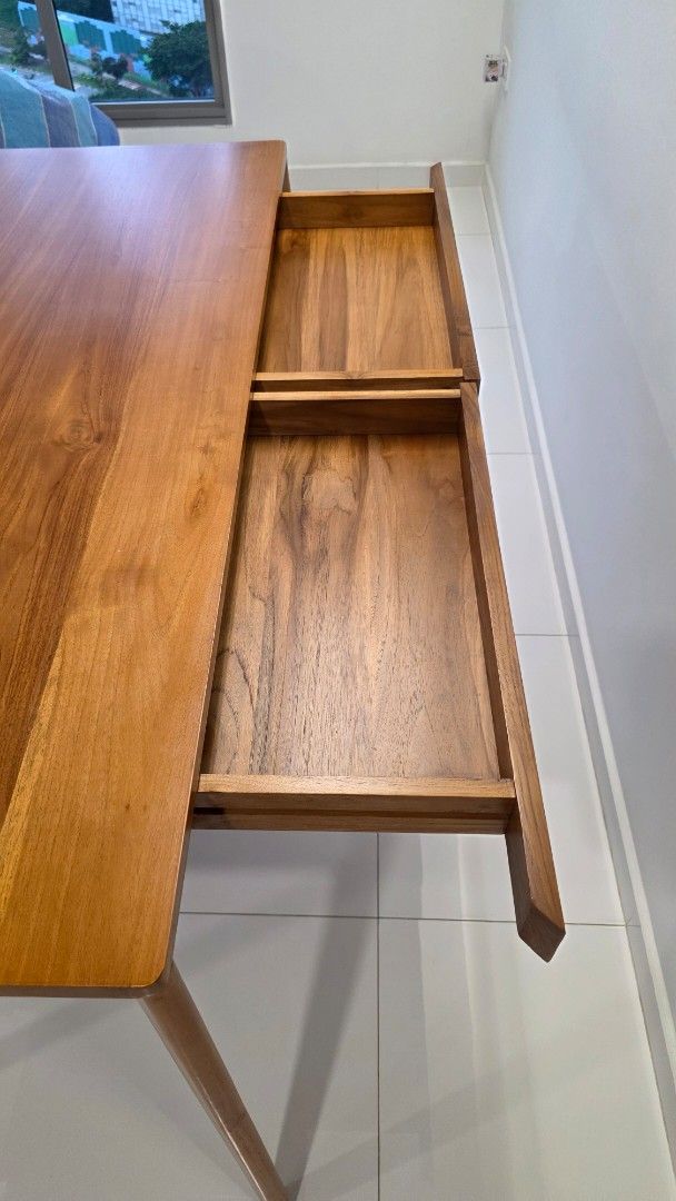 Solid Wood Study/Dinning Table (Category: Tables & Sets) located in Singapore. Submitted by tyk2323 (Listing ID 1442851238, Image 2). Description: Solid wood table with a natural wood grain and simple design. Sturdy construction with 2 drawers. Can be used as a study desk or as a dining table that seats 4 people comfortably. Dimensions are 145cm (Length) x 75cm (Breadth) x 81cm (Height). There is a bit discolouration minor dent. Buyer self- colle