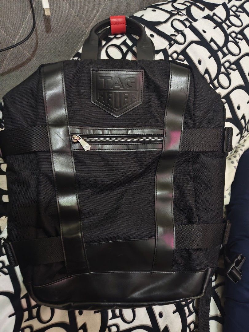 TAG HEUER Black Nylon Leather Trim Backpack (Category: Backpacks) located in Manila. Submitted by maantonett17871 (Listing ID 1442825765, Image 1). Description: - Authentic TAG HEUER backpack - Made with durable nylon and leather trim - Front zip pocket for easy access - Padded back straps for maximum comfort - Interior features TAG HEUER logo lining - Ideal for daily use, work, or travel.