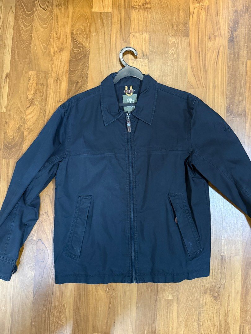Timberland Bomber Jacket (Category: Coats, Jackets and Outerwear) located in Singapore. Submitted by ngyh04 (Listing ID 1442748708, Image 1). Description: - Classic navy blue bomber jacket - Full zip closure - Two front pockets with button closures - Buttoned cuffs on sleeves - Ideal for layering - Versatile wardrobe staple.