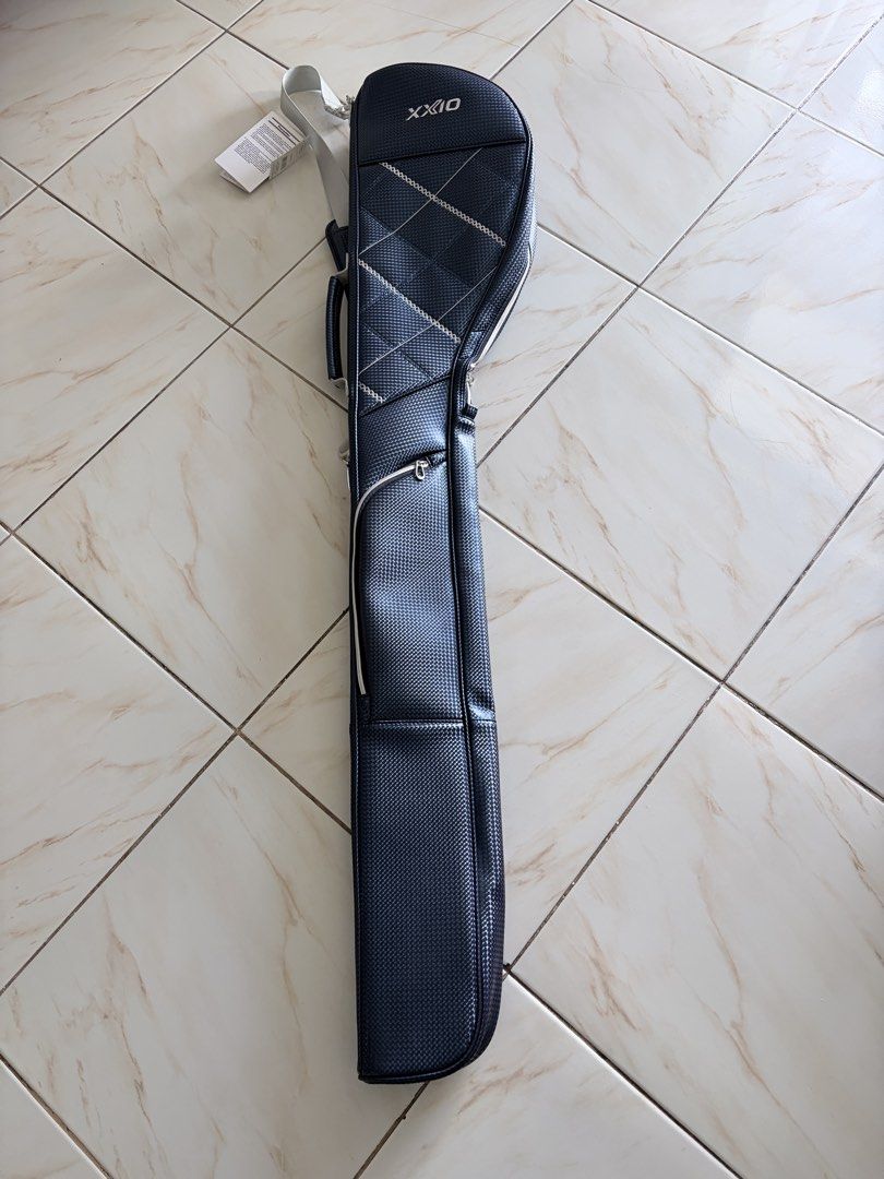 XXIO Golf Range Bag (Category: Golf) located in Taguig. Submitted by bongchie (Listing ID 1442783792, Image 2). Description: - XXIO Golf Bag - Color: Dark Blue - Material: Textured - Features: Handle and shoulder strap - Closure: Zipper - Condition: Brand new with original tag attached - Original Price: ¥9,000 - Ideal for: Carrying golf clubs.