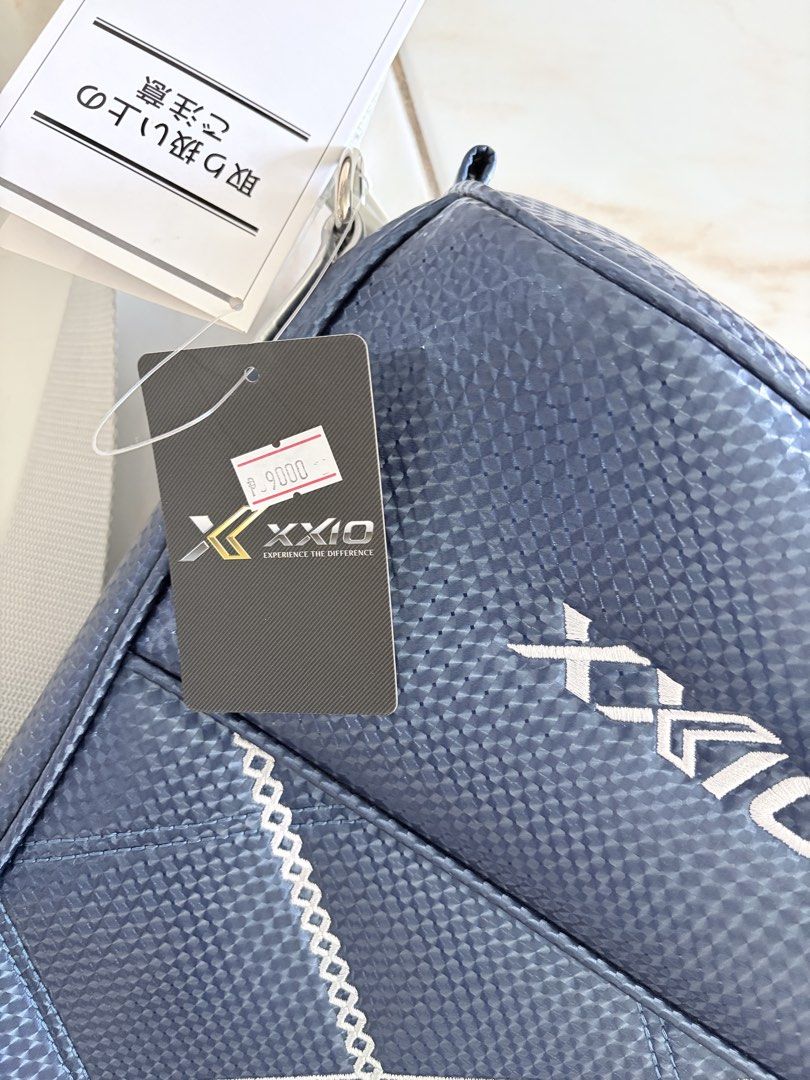 XXIO Golf Range Bag (Category: Golf) located in Taguig. Submitted by bongchie (Listing ID 1442783792, Image 1). Description: - XXIO Golf Bag - Color: Dark Blue - Material: Textured - Features: Handle and shoulder strap - Closure: Zipper - Condition: Brand new with original tag attached - Original Price: ¥9,000 - Ideal for: Carrying golf clubs.