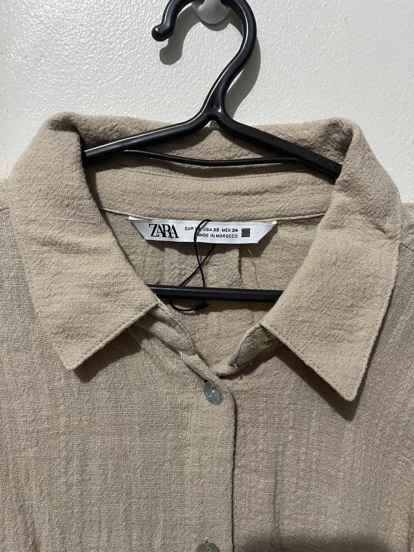 Zara Beige Textured Oversized Shirt (Category: Tshirts & Polo Shirts ) located in Pasay City. Submitted by cheesca17 (Listing ID 1442814310, Image 2). Description: - Zara oversized shirt - Nice beige color - Textured fabric - Button-up front - Comfortable and stylish - Versatile for casual or dressed-up looks - Easy to pair with any bottoms.