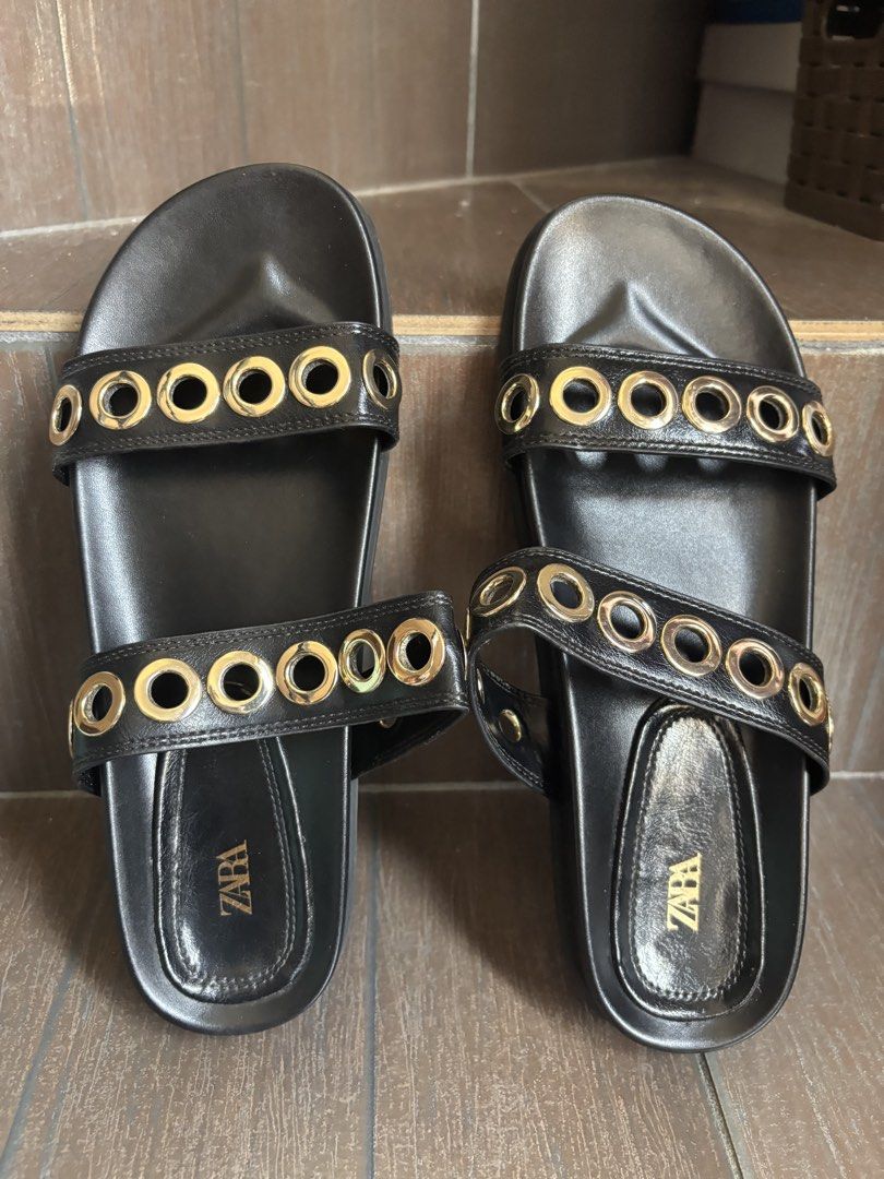 ZARA Black Leather Slides with Gold Eyelets (Category: Flats & Sandals) located in Bacoor. Submitted by mc_shopper (Listing ID 1442739575, Image 1). Description: - Zara black slide sandals - Two straps across the foot with gold-tone eyelets - Easy slip-on style - ZARA logo on insole - Ideal for casual wear - regular price 2,995.