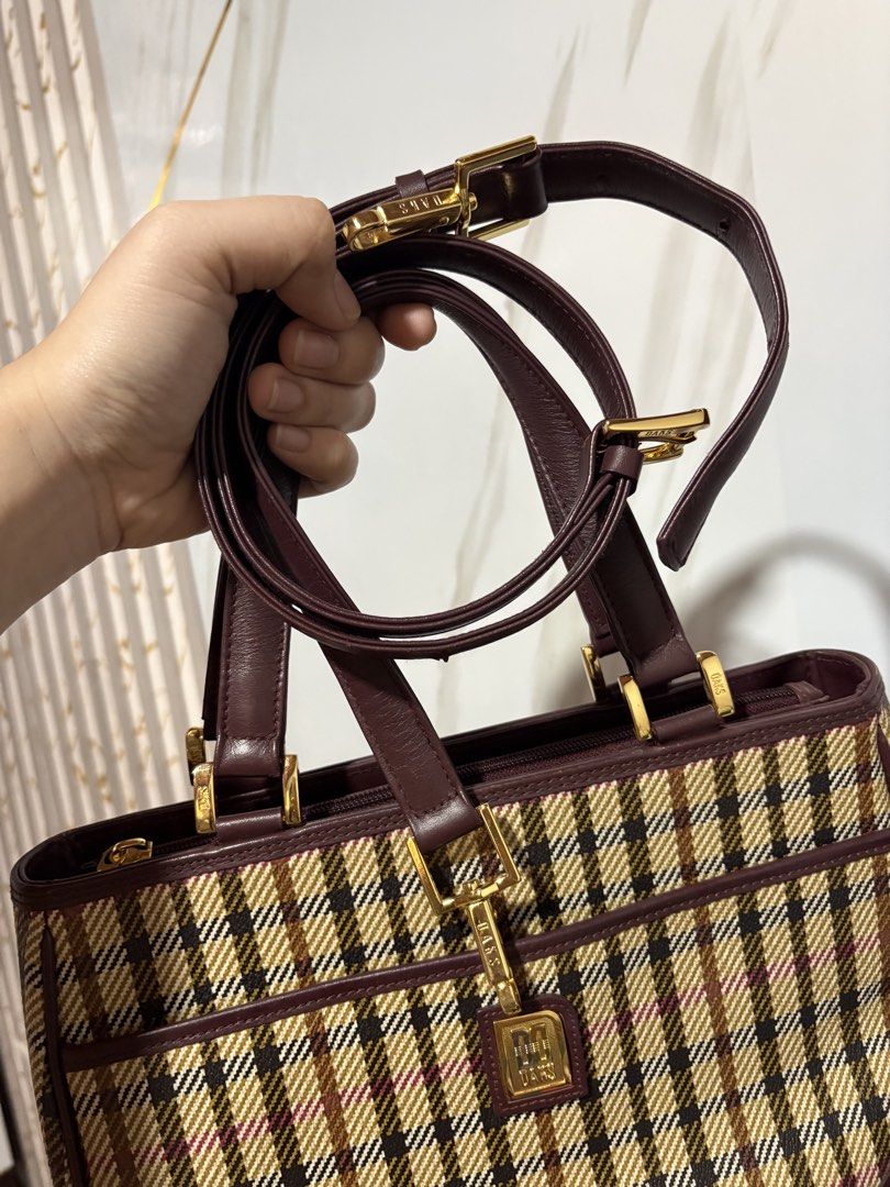 Authentic DAKS handbag/slingbag (Category: Luxury Bags & Wallets) located in Manila. Submitted by queenjinae_013 (Listing ID 1446933209, Image 2). Description: - DAKS handbag &Sling bag - Iconic plaid pattern with leather trim - Gold hardware details - Top handles and detachable shoulder strap - Spacious interior for essentials - Ideal for vintage collectors 98% gold hardware Looks new.