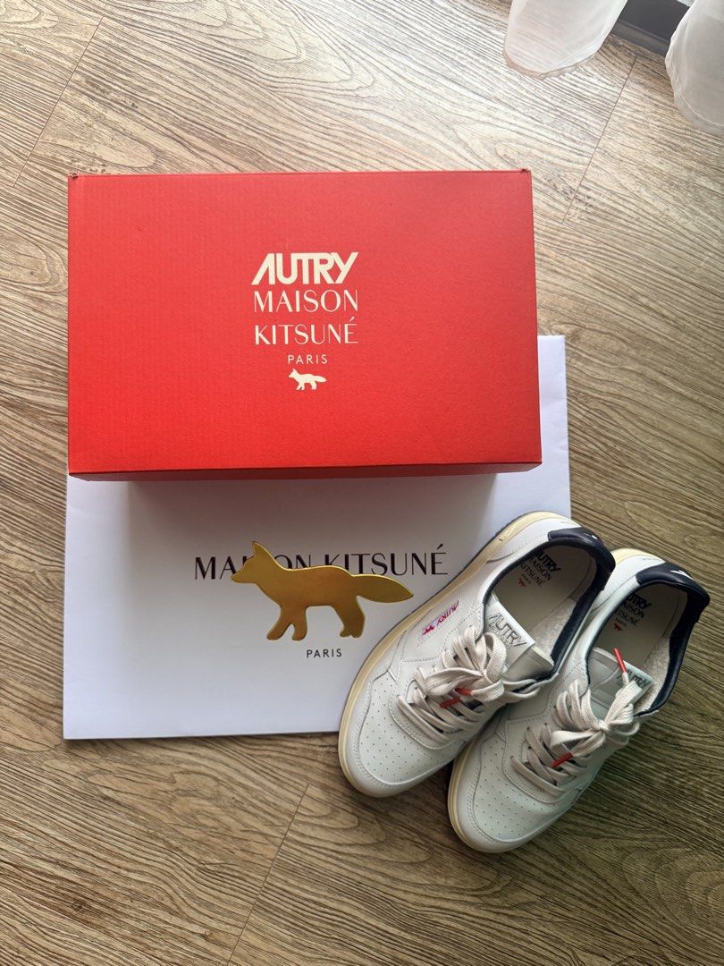 Autry Maison Kitsune Shoes Medalist Sneakers White (Category: Casual Shoes) located in Pasig City. Submitted by thetravellingguyinstyle (Listing ID 1441756340, Image 1). Description: - Classic white leather sneakers by Autry x Maison Kitsune - White Sneakers, Navy blue accents on heel tab and sole - Perforated toe box for breathability - Secure lace-up closure - Comfortable and stylish for everyday wear - Complete with box - Guaranteed Authentic 