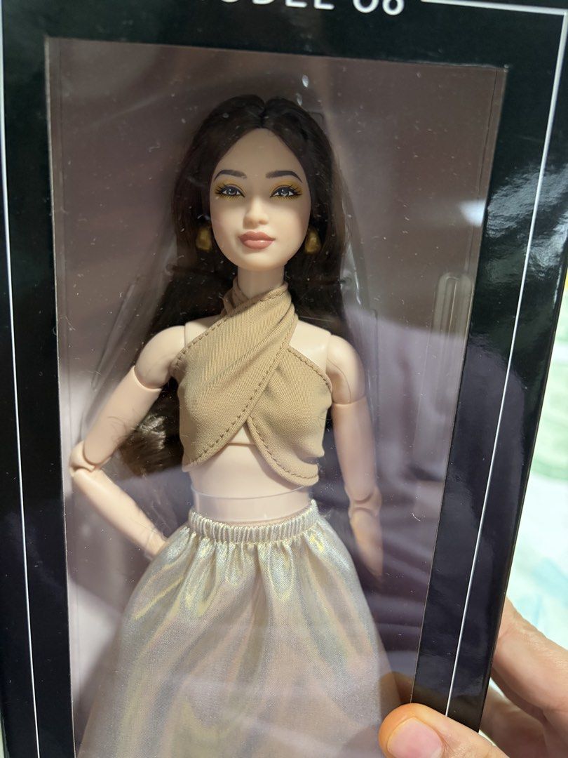 Barbie Basics Model 06 Doll (Category: Kids Toys) located in Cebu City. Submitted by khaleesimicmita (Listing ID 1446994507, Image 2). Description: - Barbie Basics Model 06 doll - Brand new, in original packaging - Features long dark hair - Wears a stylish gold top and skirt - Ideal addition for any Barbie collector - box in pristine condition unopened.