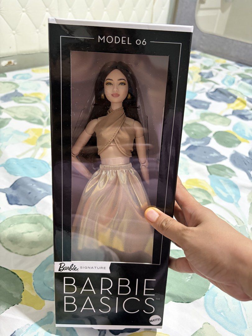 Barbie Basics Model 06 Doll (Category: Kids Toys) located in Cebu City. Submitted by khaleesimicmita (Listing ID 1446994507, Image 1). Description: - Barbie Basics Model 06 doll - Brand new, in original packaging - Features long dark hair - Wears a stylish gold top and skirt - Ideal addition for any Barbie collector - box in pristine condition unopened.