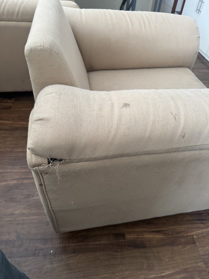 Beige Armchair - Single Seat Sofa (Category: Chairs) located in Manila. Submitted by rockypeach (Listing ID 1446915018, Image 3). Description: 1,500 per piece, 2,500 take both - Beige single-seat armchair - Upholstered in soft fabric - Shows wear and tear, particularly on arms and underside - Large tear on the back exposing internal springs - Still functional, but requires repair - Ideal for DIY projects or spaces where condition is not a primary